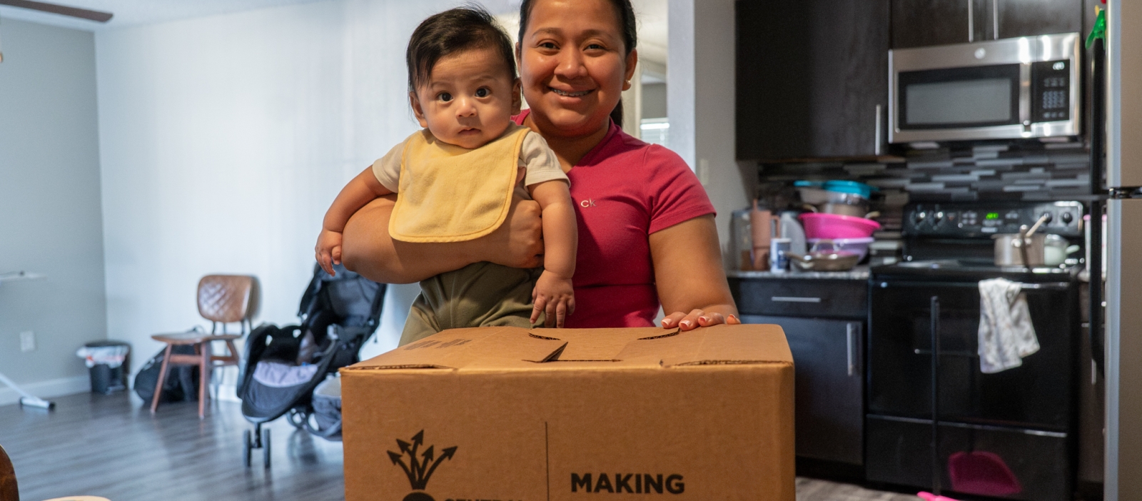 Mom and baby with CTFB's Medically Tailored Meals delivery box