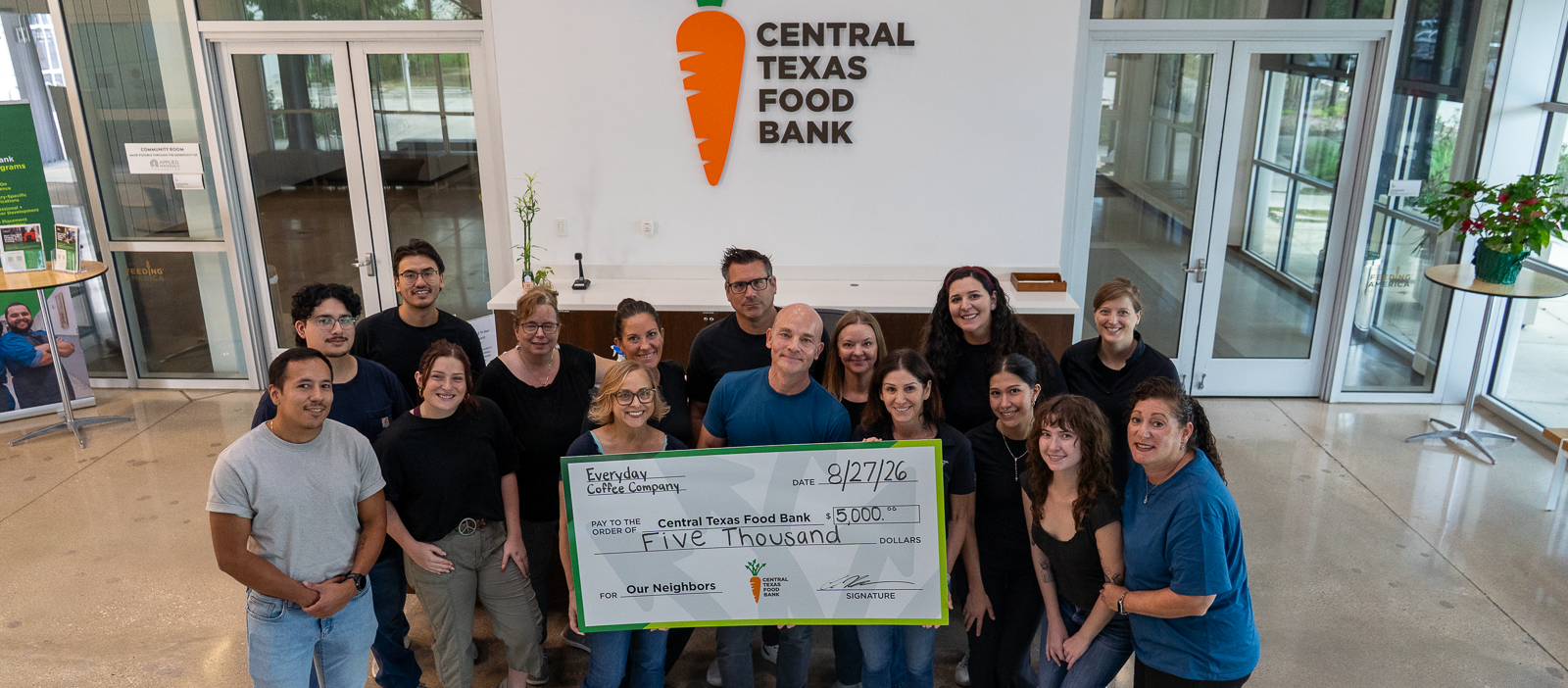 CTFB Donors Everyday Coffee Company holding check in Austin facility lobby